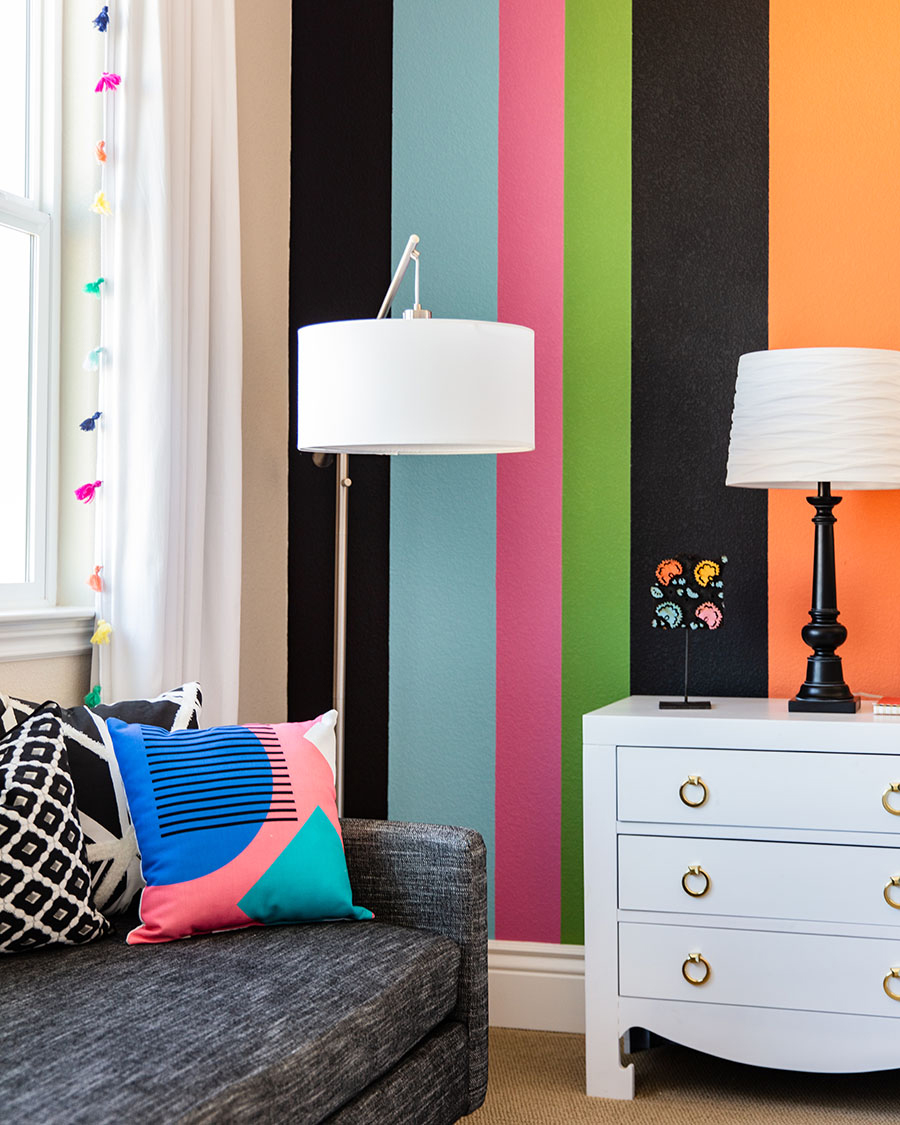 colorful kids bedroom with multi color walls, lamp and bedroom furniture