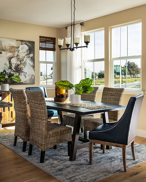 modern sun room dining table with wicker chairs